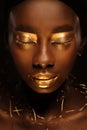 Portrait of beautiful african woman with creative gold makeÃ¢â¬âup and jewelry